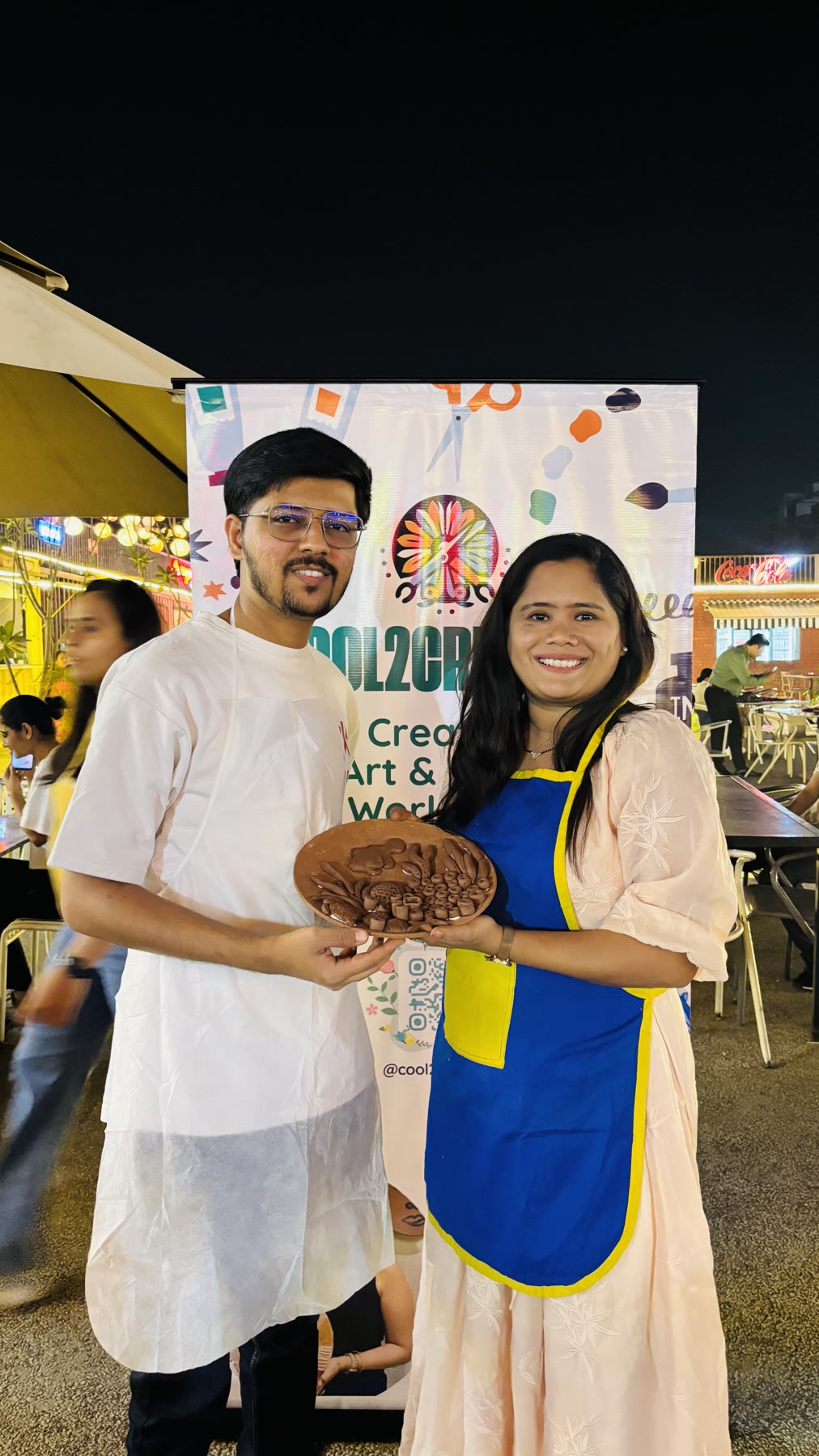 A couple smiling with the clay artwork they made together